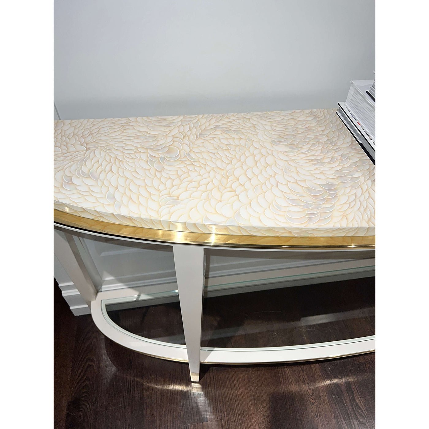 Close-up of demilune console table ornate top design.