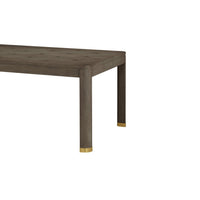 Close-up of dining table corner, gold-tipped legs.