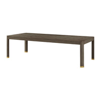 Dark wood dining table with gold accents, angled view.