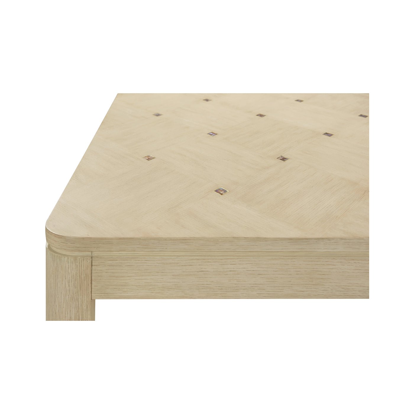 Corner detail of dining table, light wood pattern.