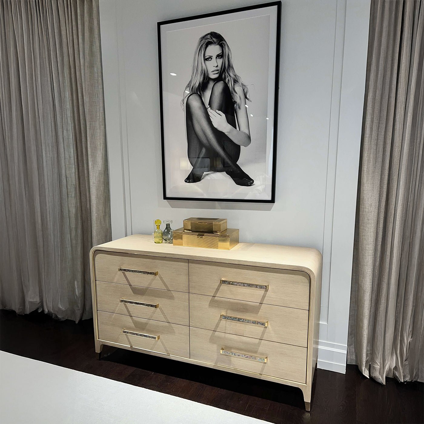Dresser with decor, large black-and-white photo above.