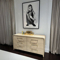Dresser with decor, large black-and-white photo above.