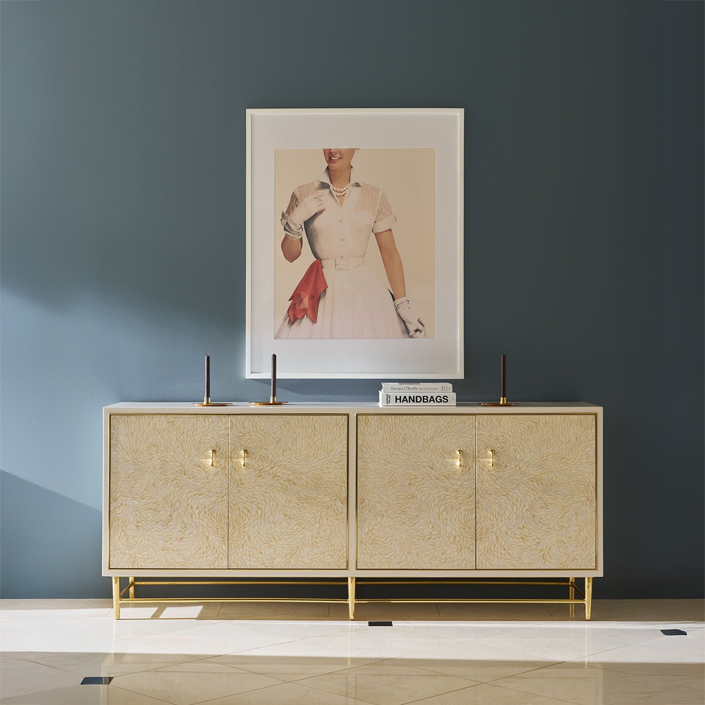 Hollywood Regency cabinet styled in room with artwork above.
