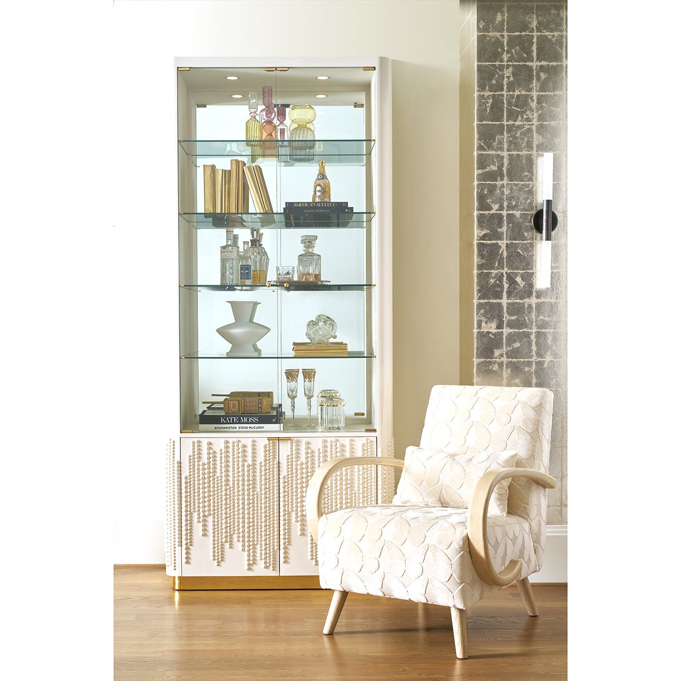 Bookcase styled with books and decor items in room.