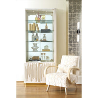 Bookcase styled with books and decor items in room.