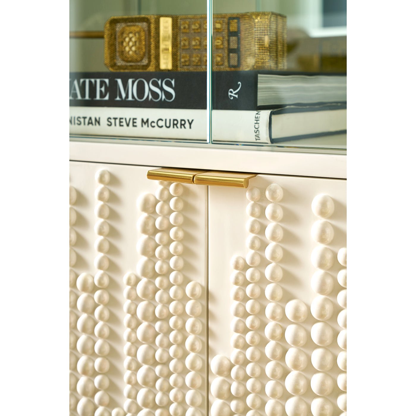Close-up of textured cabinet doors on bookcase.