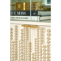 Close-up of textured cabinet doors on bookcase.