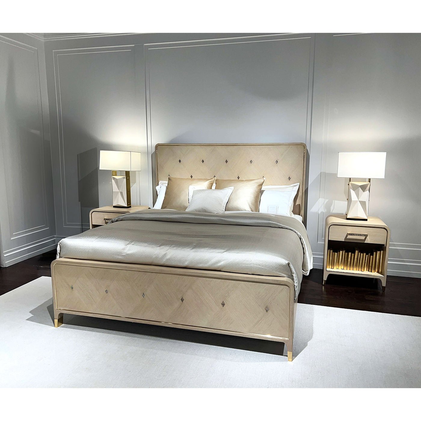 Hollywood Regency king bed in room with lamps, light finish.