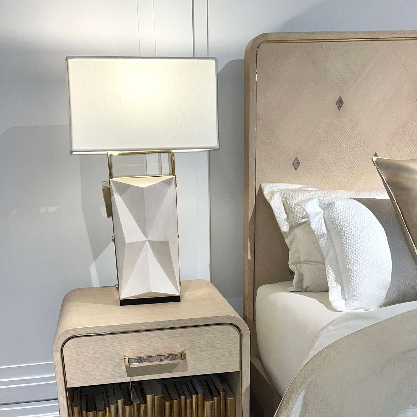 Nightstand and lamp beside Hollywood Regency king bed.