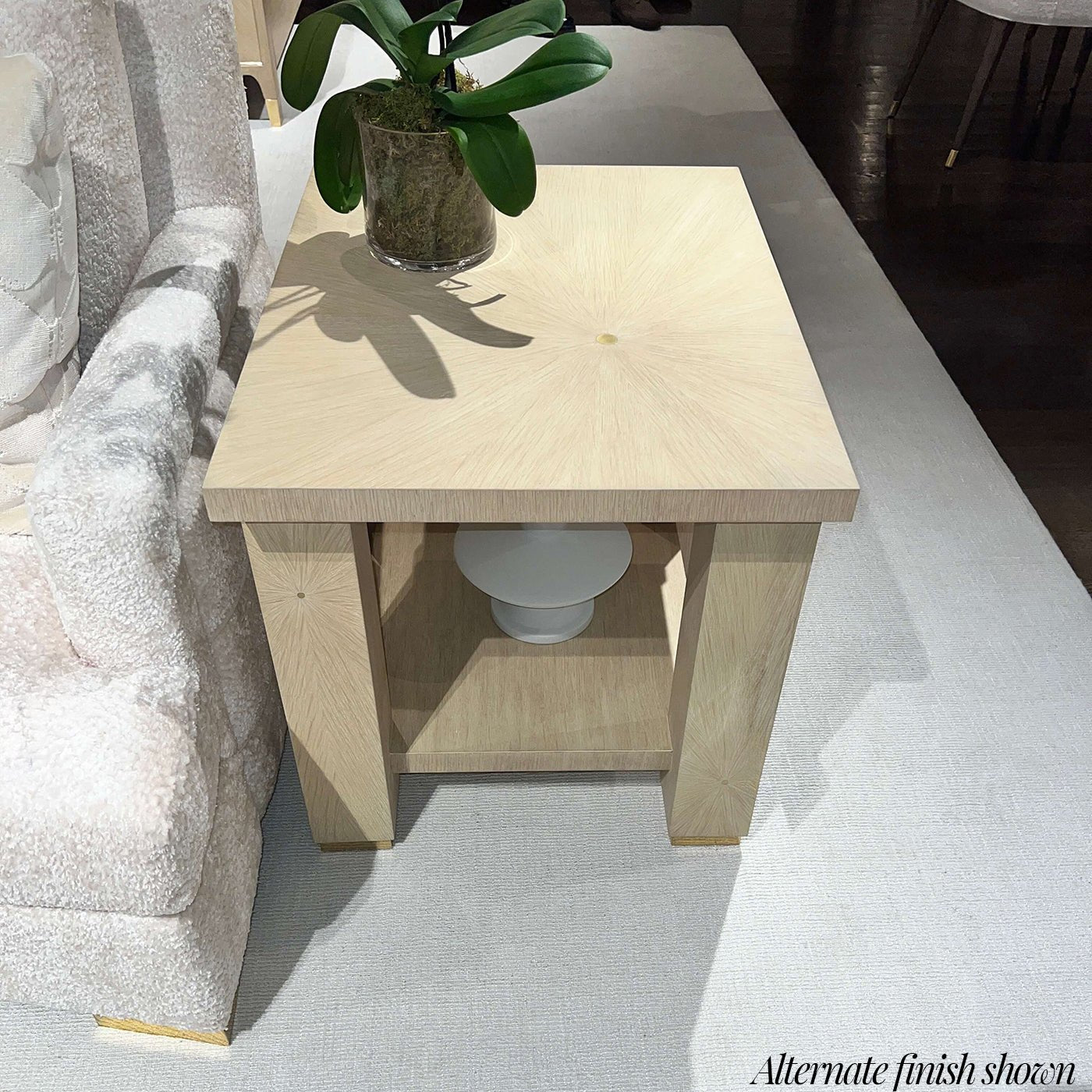 Light finish end table beside seating, stylish decor accent.