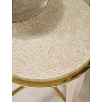 Detailed view of table's patterned surface and gold edging.