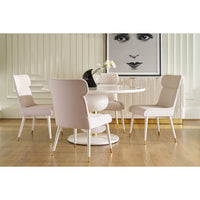 Dining table with blush chairs in elegant room setting.