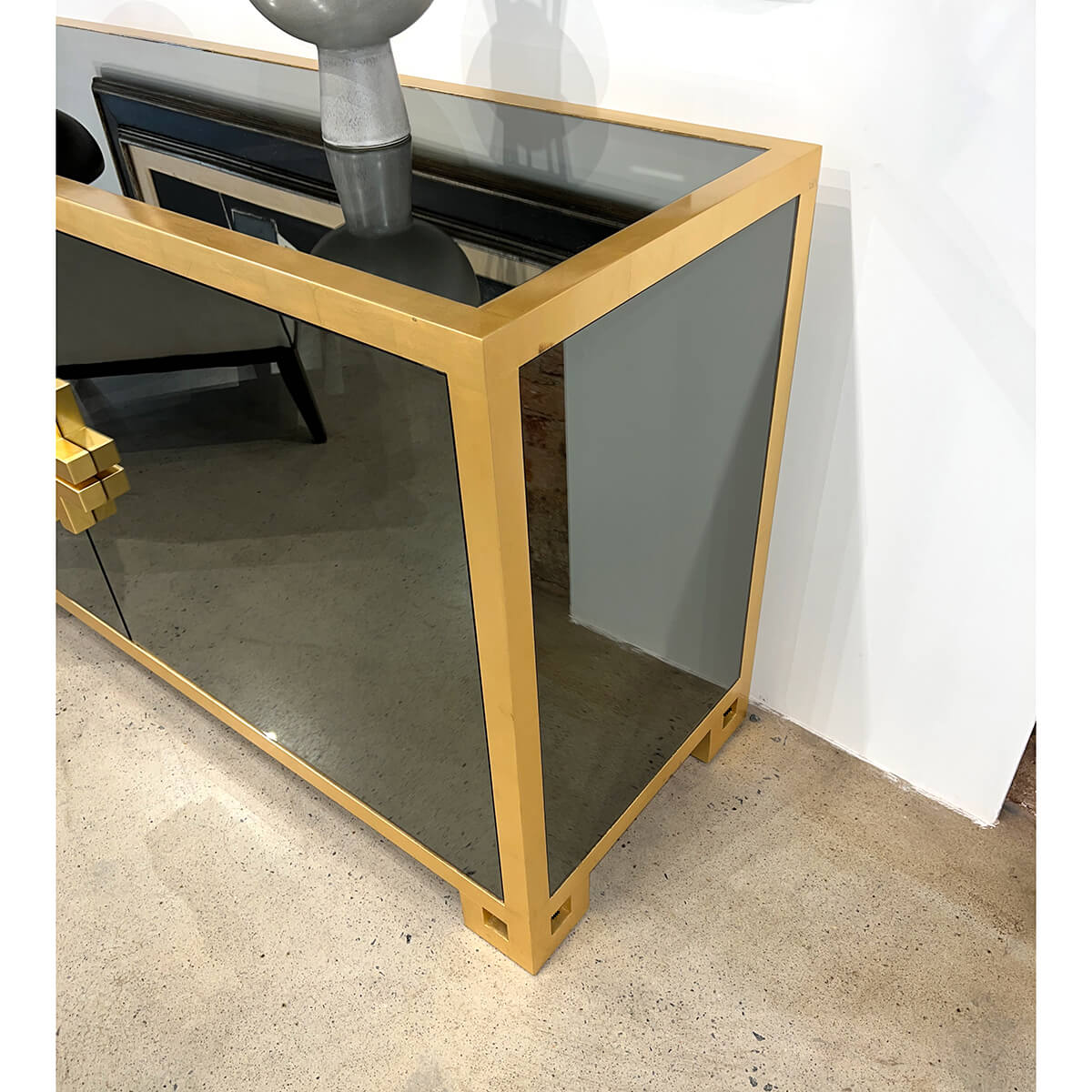 Side view of sideboard highlighting gold frame and details.