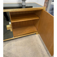 Inside of sideboard showing wooden shelves, door open.