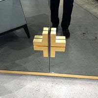 Close-up of gold handle on sideboard door.