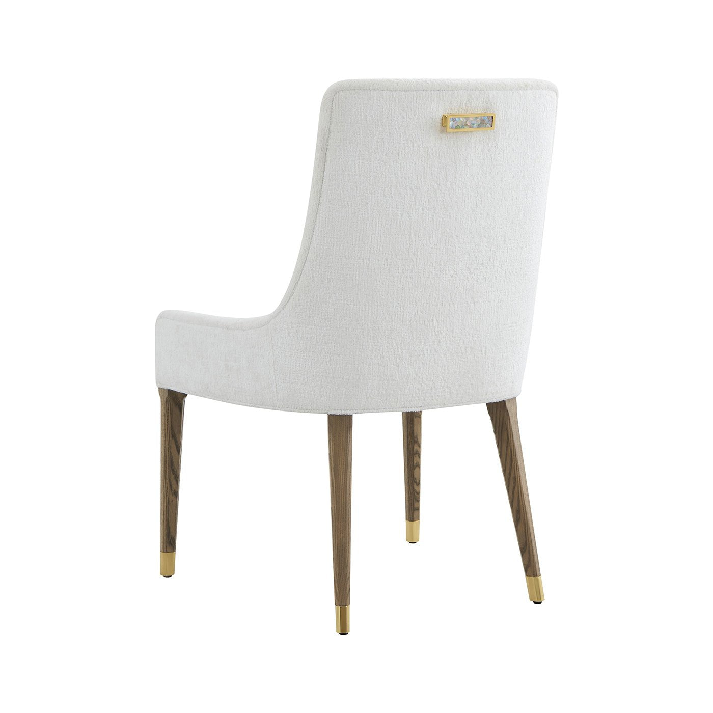 Dining chair back view showing gold-tipped legs, decorative detail.