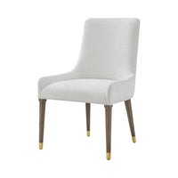 White upholstered dining chair with gold accents, front view.