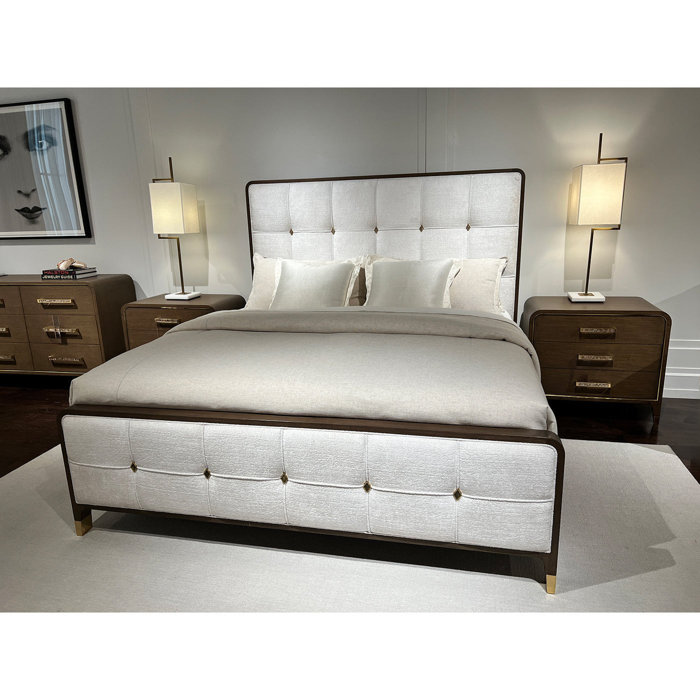Room view with upholstered king bed and matching furniture.