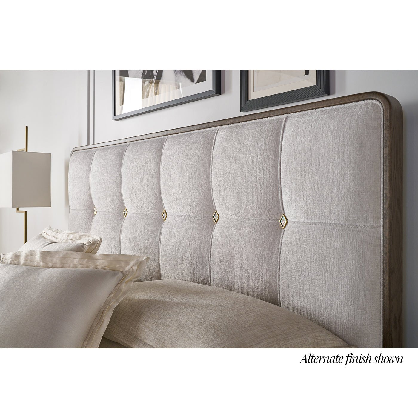 Close-up of upholstered king bed headboard details.