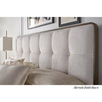 Close-up of upholstered king bed headboard details.