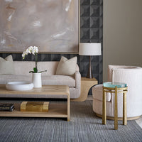 Coffee table in elegant room setting with decor.