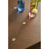 Flower arrangement on dark coffee table, top detail.