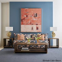 Floral-patterned lounge with matching side tables and lamps.