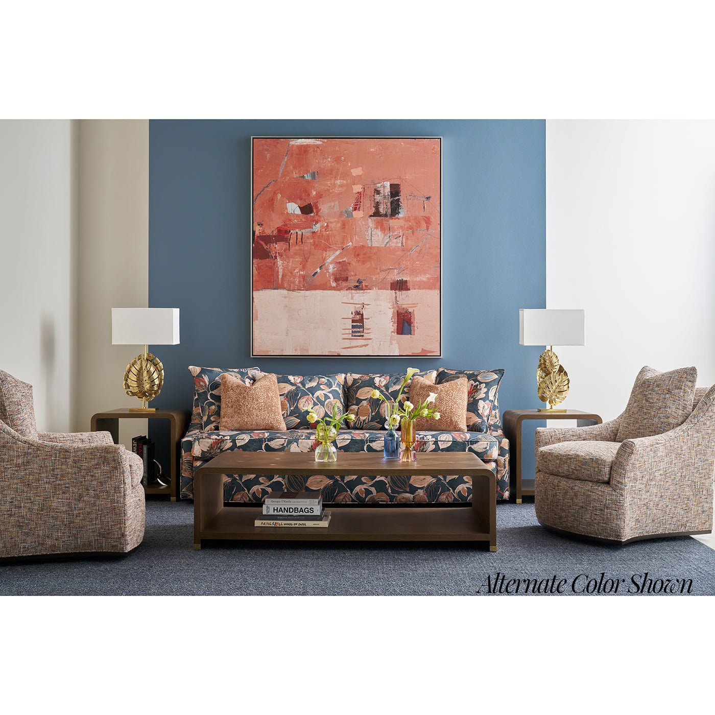 Alternate color lounge setup with floral sofa and tables.