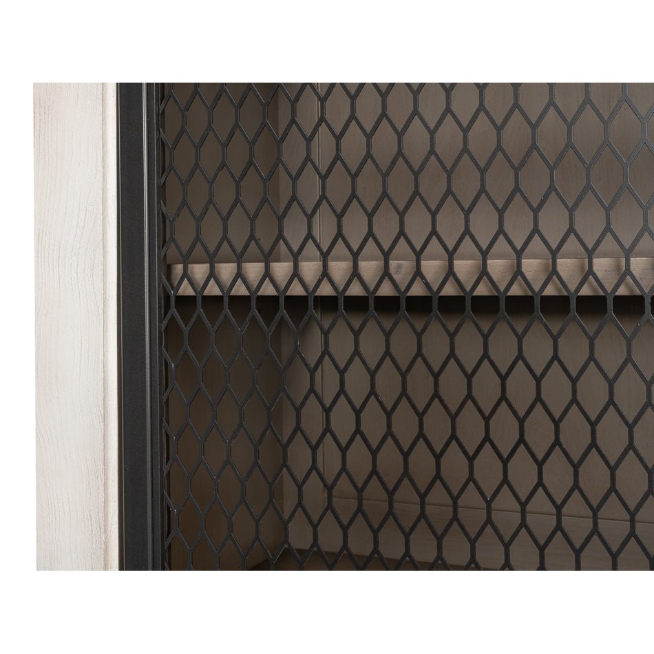 Close-up of metal mesh door on industrial bar cabinet.