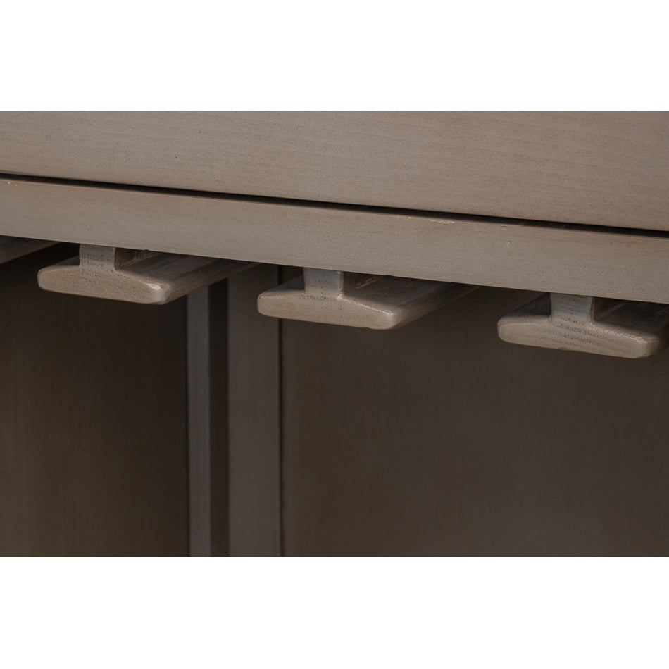 Wine glass holders detail in industrial bar cabinet.