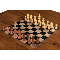 Close-up of chess pieces on wooden coffee table.
