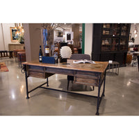 Industrial equestrian desk in modern showroom setting.