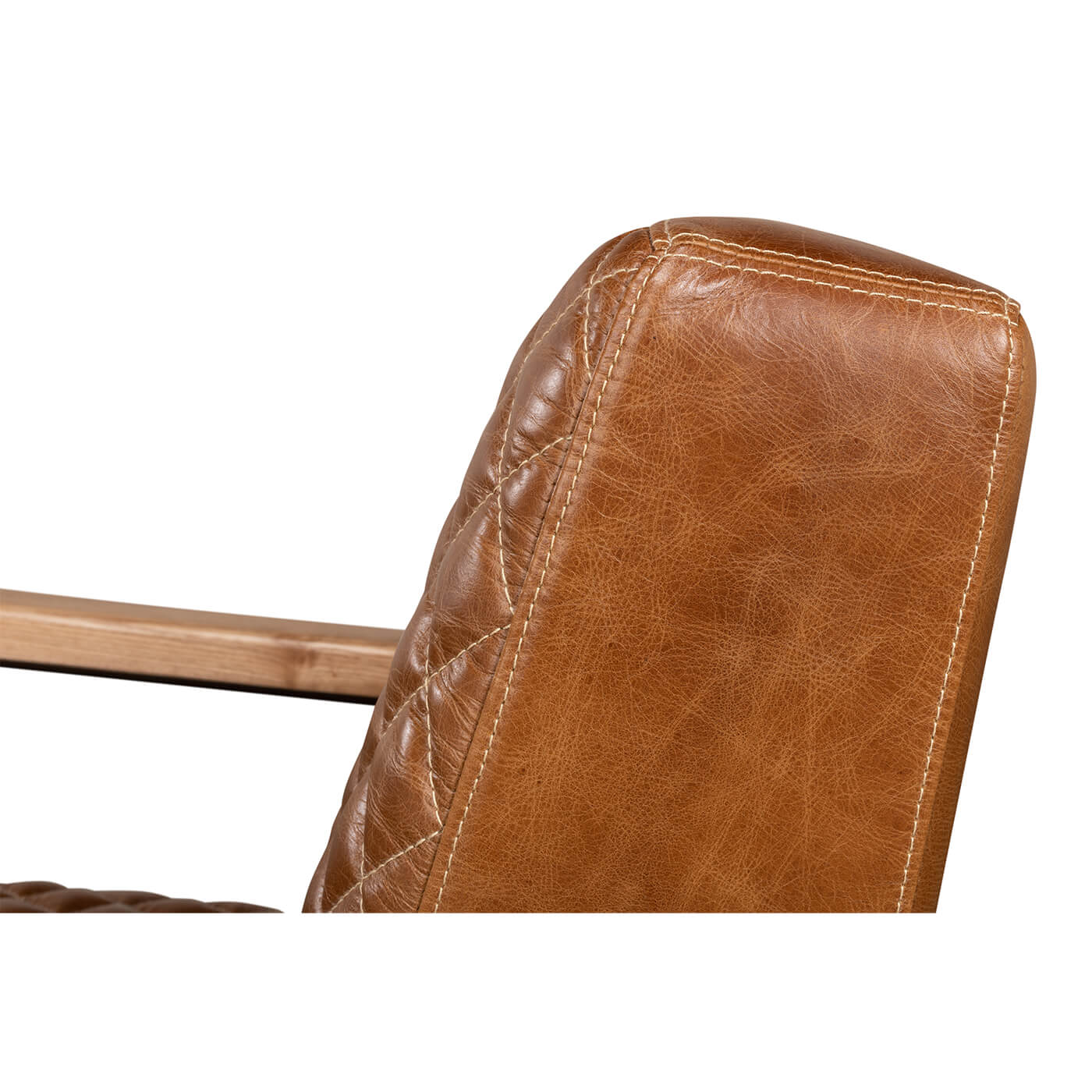Close-up, leather texture and stitching on armchair back.