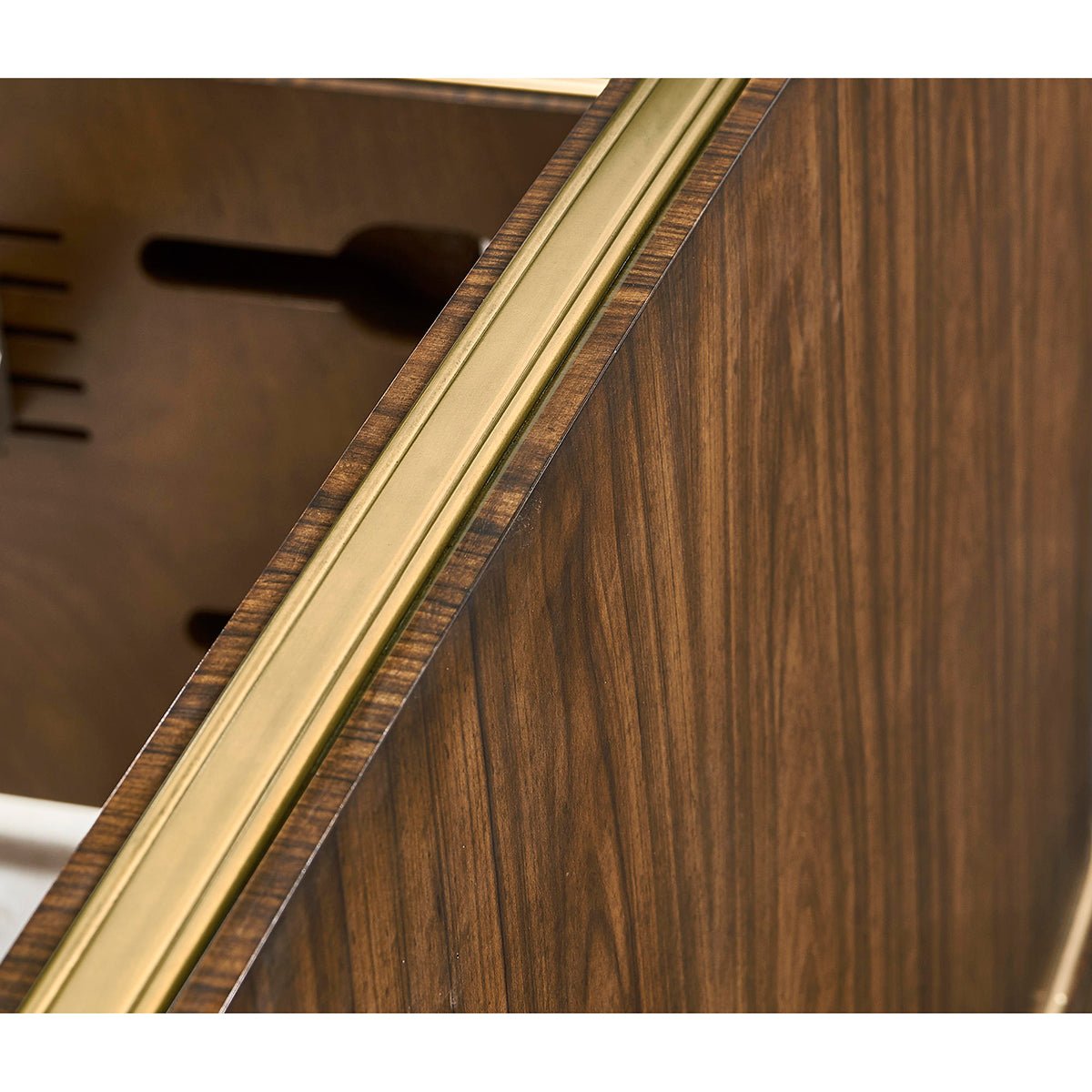 Brass accent detail on wooden king bed footboard.