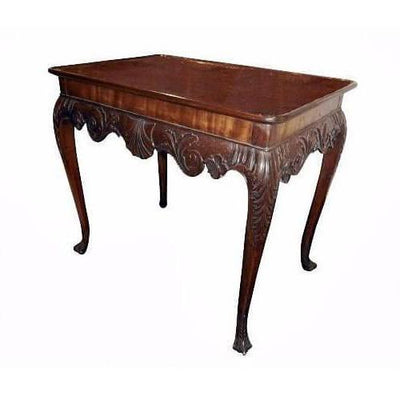 Mahogany silver table with ornate carved legs, side view.