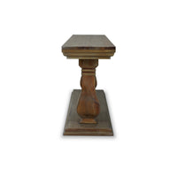 Side view of wooden console table's carved legs.