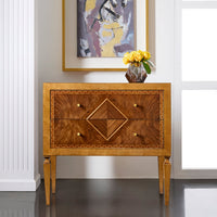 Nightstand in elegant room setting with abstract artwork.