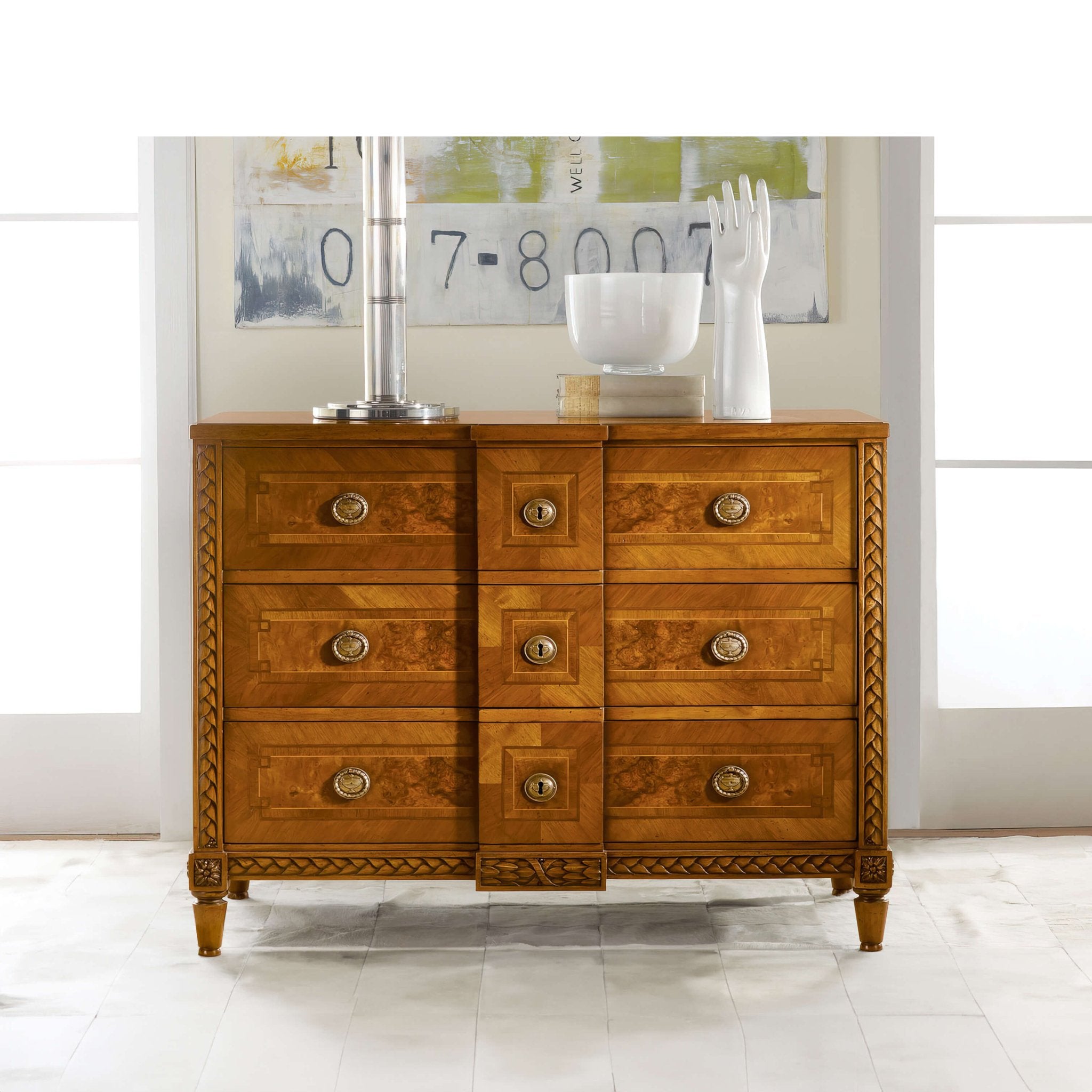 Italian commode styled with decor, in bright room.