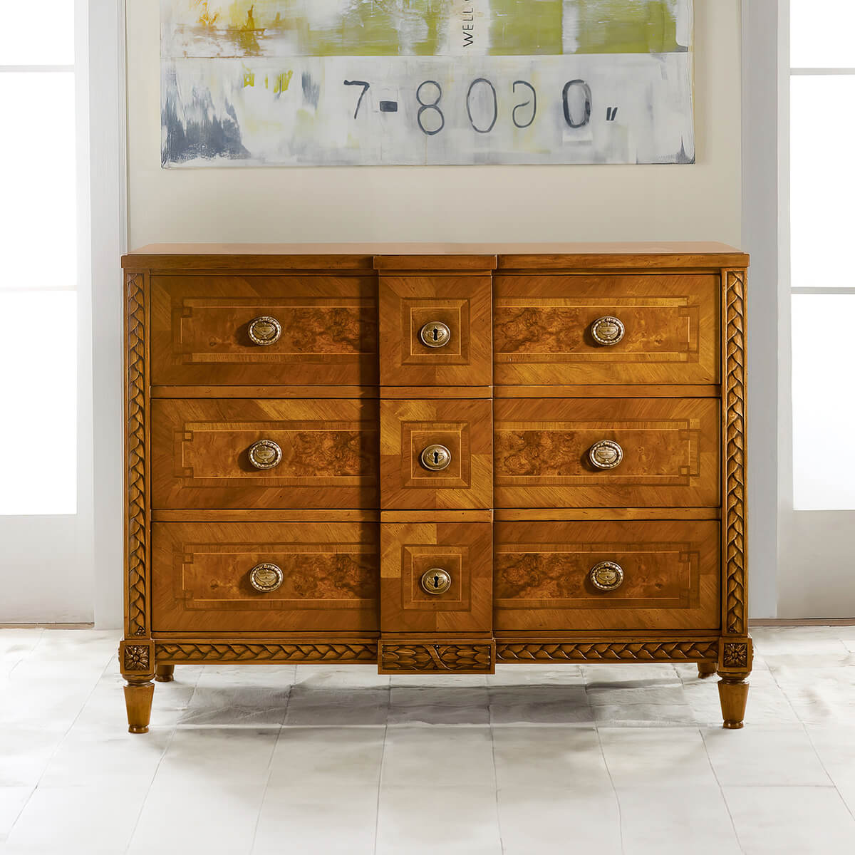 Italian walnut commode under modern art, in natural light.