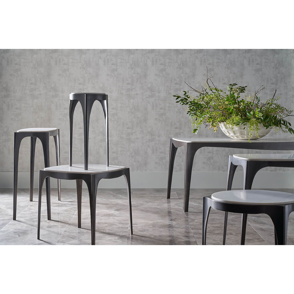 Collection of modernist tables and chairs in styled room.