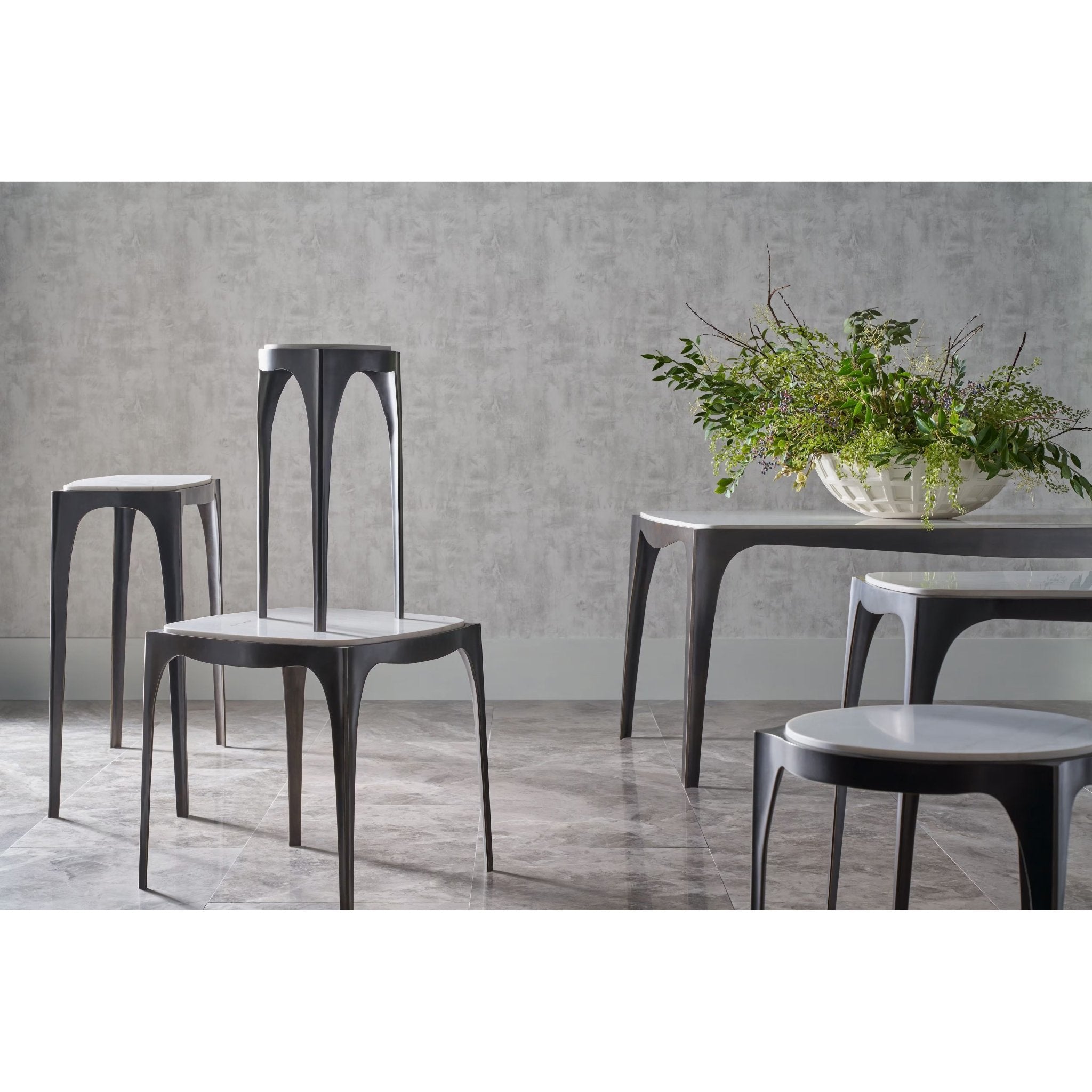 Set of Italian modernist side tables in room setting.