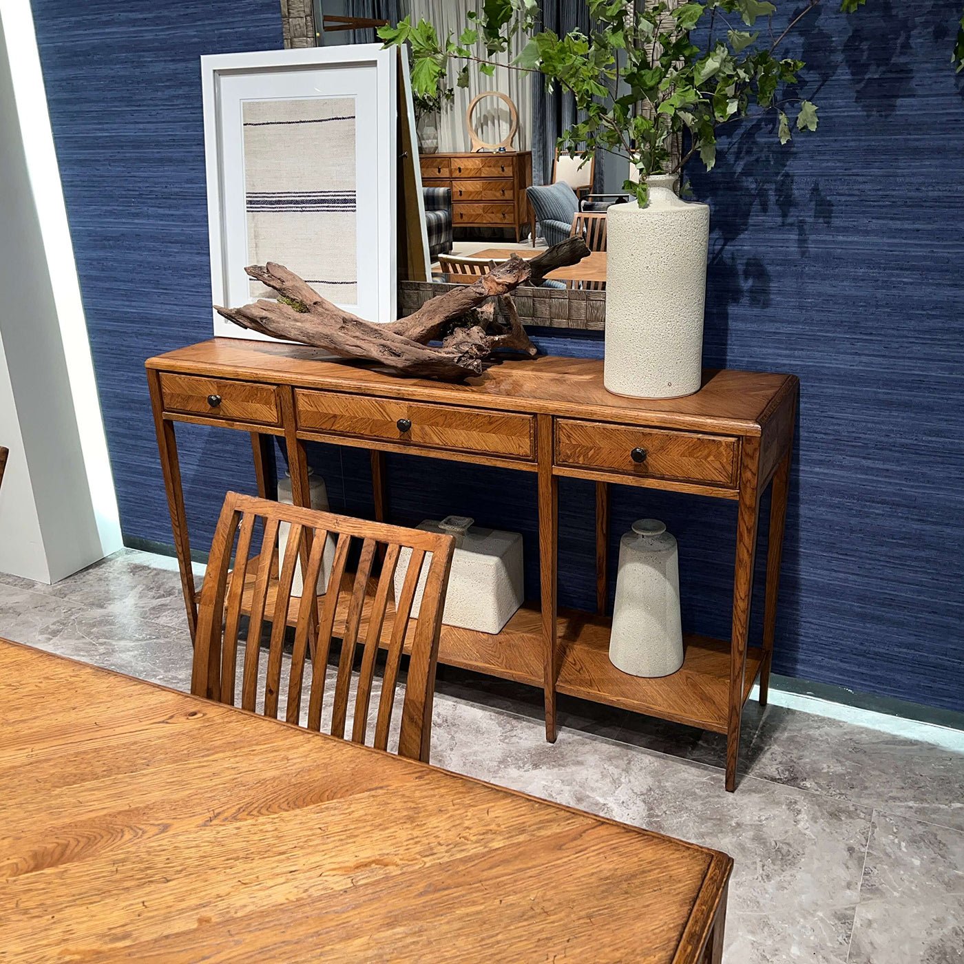 Italian oak console table staged with decorative items.
