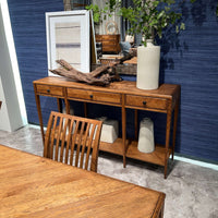 Italian oak console table staged with decorative items.
