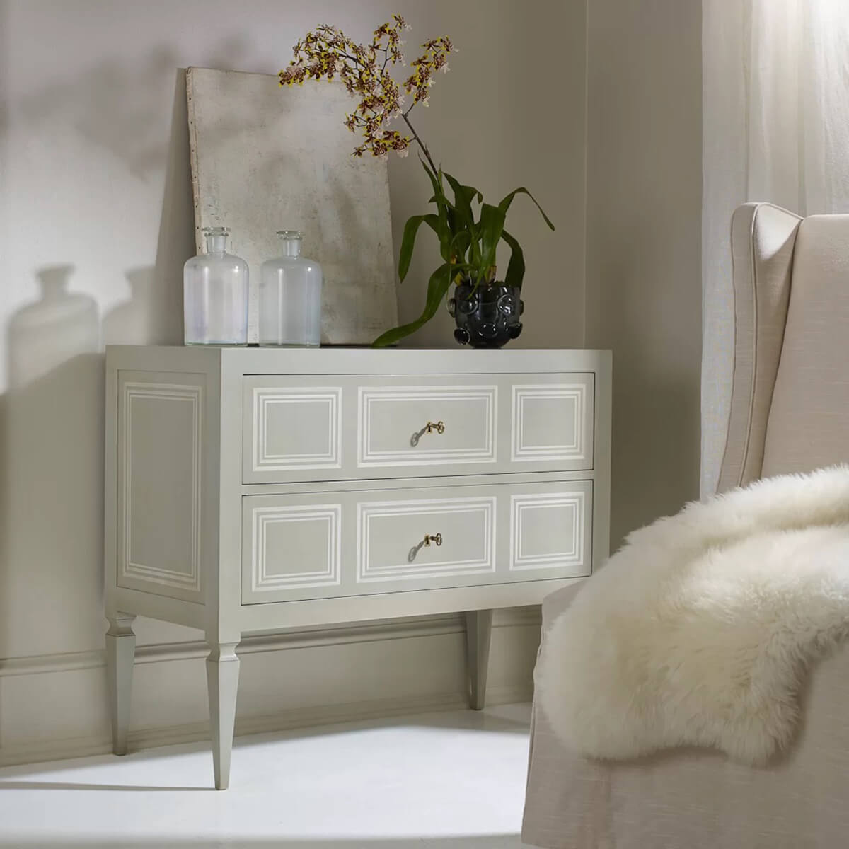 Decorated Italian Neo Classic commode with plants and ornaments.