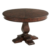 Round dining table, side angle showing pedestal detail.