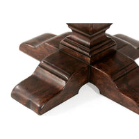 Detailed view of dining table's pedestal foot design.