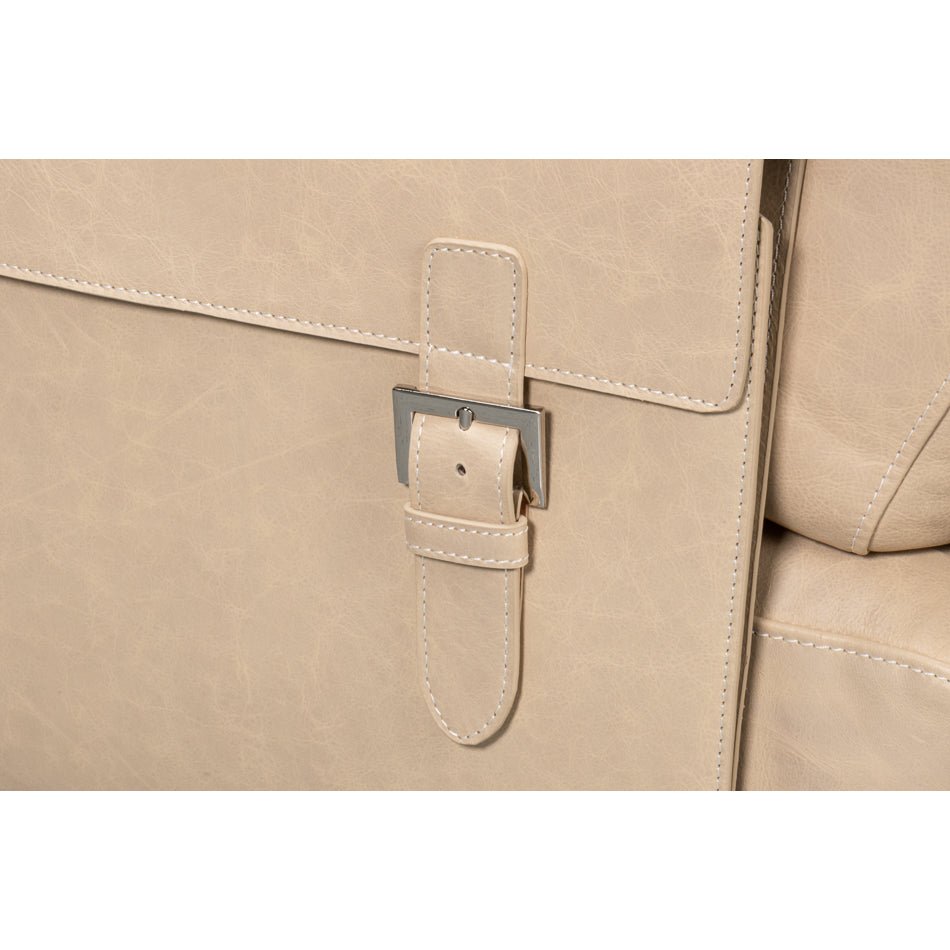 Buckle detail on ivory leather chair side pocket.