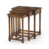 Three Jacobean style nesting tables stacked together.