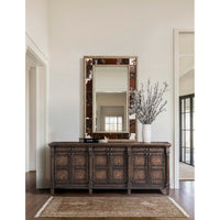 Sideboard in bright room with decorative mirror.