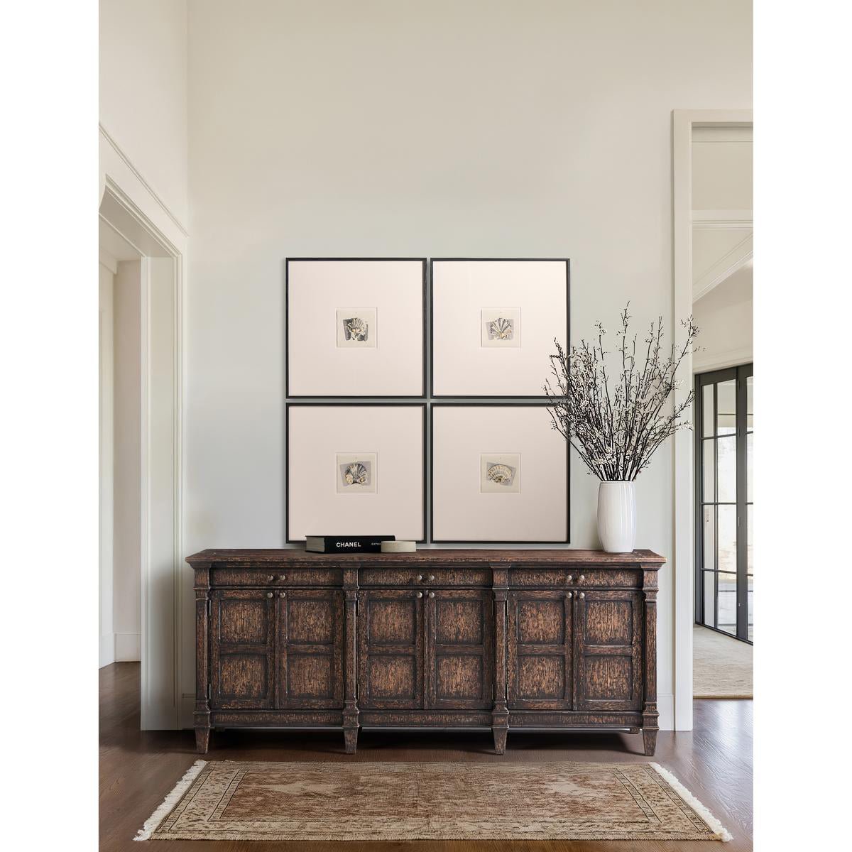 Wooden sideboard with framed art above, elegant setting.